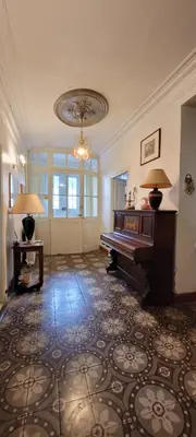 a living room with a piano and a chandelier at Comme à la Maison - Accueil tout Public - Groupes - Rando - Vélos - Motos in Saint-Paul-de-Fenouillet