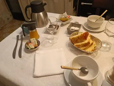 a table with a plate of cake and wine glasses at L'écrin in Lacroisille