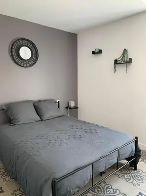 a bedroom with a large bed in a room at Appartement cœur de village Numéro1 in Peyriac-de-Mer