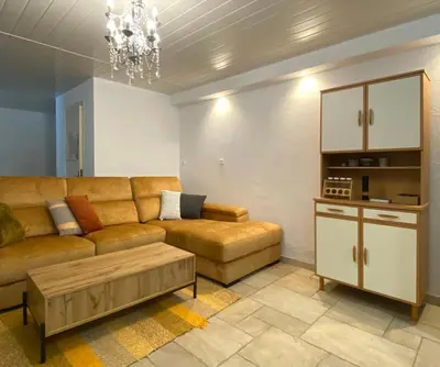 a living room with a couch and a coffee table at Appartement avec accès privé à la rivière in Ladern-sur-Lauquet