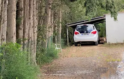 a dirt road in a field with trees and buildings at Appartement avec accès privé à la rivière in Ladern-sur-Lauquet