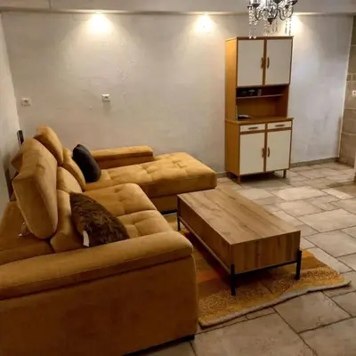 a patio with chairs and a table in front of a building at Appartement avec accès privé à la rivière in Ladern-sur-Lauquet
