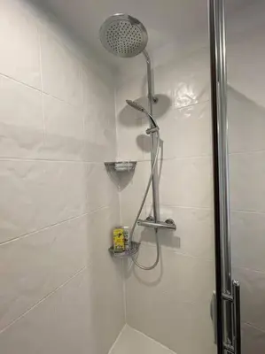 a shower with a shower head in a bathroom at Appartement 2 chambres +parking in Narbonne