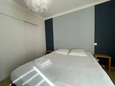 a bedroom with a bed with two towels on it at Appartement 2 chambres +parking in Narbonne