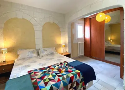 a bedroom with a bed and a large mirror at Gîte avec jacuzzi, et accès privé à la rivière in Ladern-sur-Lauquet