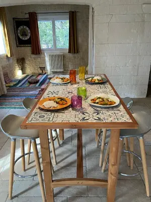 a wooden table with plates of food on it at Gîte avec jacuzzi, et accès privé à la rivière in Ladern-sur-Lauquet