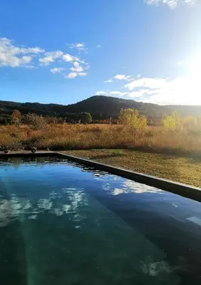 a pool of water with a view of a field at Piano apartment in Taurize
