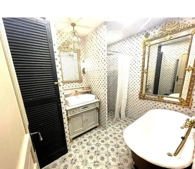 a bathroom with a sink and a toilet and a mirror at Piano apartment in Taurize