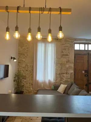 a living room with a table and a couch at Loccitan in Capestang