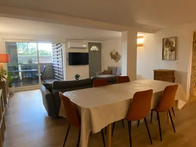 a living room with a table and a couch at T3 bis bord du canal du midi piscine in Homps