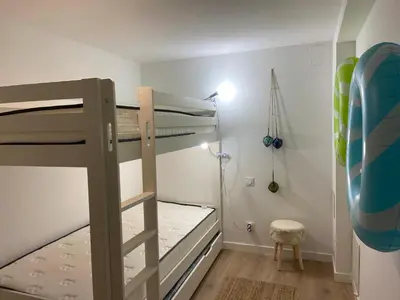 a bedroom with two bunk beds and a lamp at T3 bis bord du canal du midi piscine in Homps