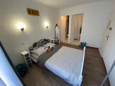 a bedroom with a large bed in a room at Os-thel, Chambres à louer in Tautavel