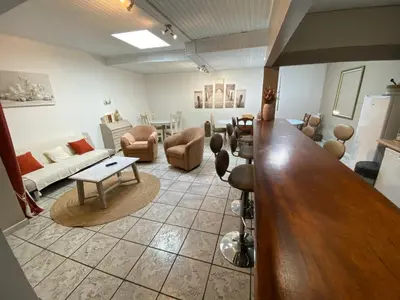 a large living room with a large wooden bar at Os-thel, Chambres à louer in Tautavel