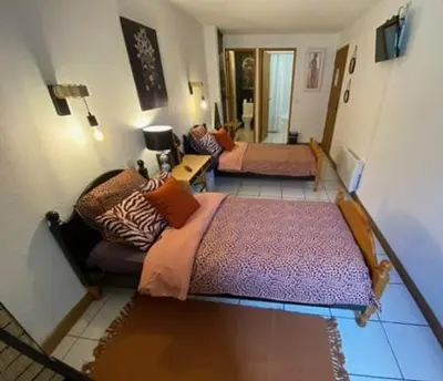 a living room with two beds and a couch at Os-thel, Chambres à louer in Tautavel