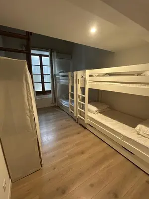 a room with two bunk beds and a wooden floor at Maison, canal du midi piscine in Homps