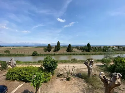 a view of a river with statues of animals at Maison, canal du midi piscine in Homps