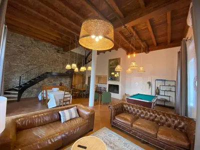 a living room with leather furniture and a pool table at Maison, canal du midi piscine in Homps