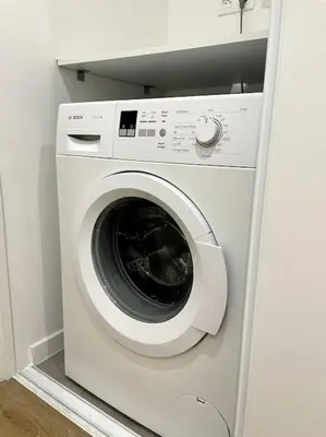 a white washer and dryer in a room at Cozy & Elegant Appartement Narbonne in Narbonne
