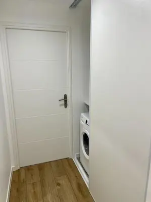 a door leading into a room with a microwave at Cozy & Elegant Appartement Narbonne in Narbonne