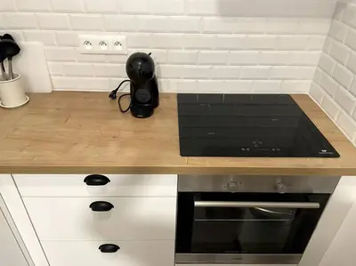 a kitchen with a counter top with a stove top oven at Cozy & Elegant Appartement Narbonne in Narbonne