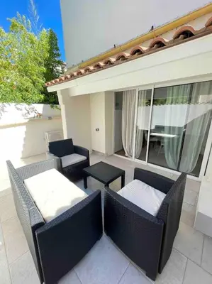 an outdoor patio with two chairs and a table at Cozy & Elegant Appartement Narbonne in Narbonne