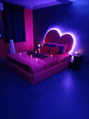 a bedroom with a heart shaped bed with lights at L'instant romance Le Romantique in Castelnaudary