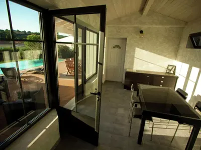 a house with a view of a pool and a glass door at Serene Villa Stay near Narbonne in Narbonne