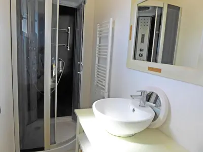 a white bathroom with a sink and a shower at Serene Villa Stay near Narbonne in Narbonne