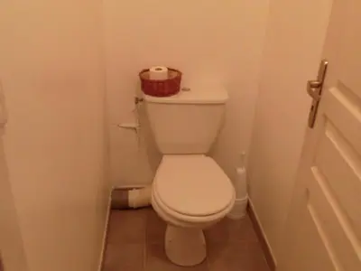 a bathroom with a toilet with a basket on top of it at Serene Villa Stay near Narbonne in Narbonne