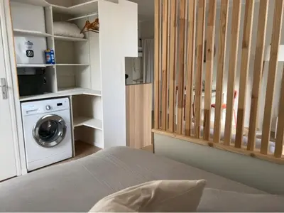 a bedroom with a washing machine and a washer at Studio hyper centre de castres in Castres