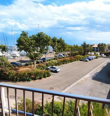 a view of a parking lot from a balcony at APPARTEMENT DE VACANCES A LA MER DANS RESIDENCE SECURISEE in Gruissan