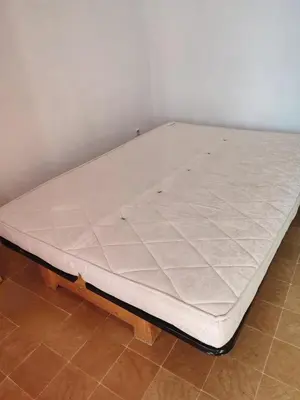 a mattress on a bed frame in a room at APPARTEMENT DE VACANCES A LA MER DANS RESIDENCE SECURISEE in Gruissan