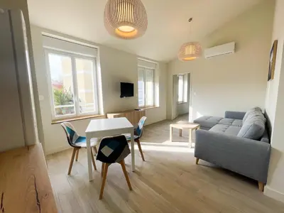 a living room with a couch and a table at Le Baya - Appt proche des Halles in Narbonne