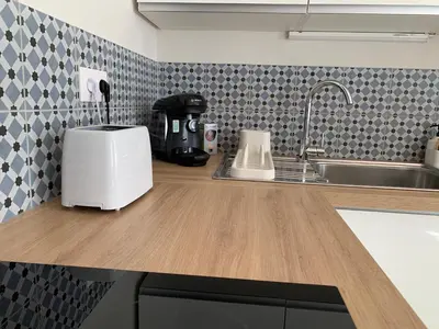 a kitchen counter with a toaster and a sink at Le Woltu - Appt proche des Halles in Narbonne