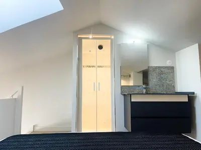 a room with a door and a sink and a mirror at Le Woltu - Appt proche des Halles in Narbonne
