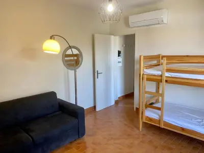 a living room with a couch and a bunk bed at Beau T3 - plain pied - terrasses in Port-la-Nouvelle