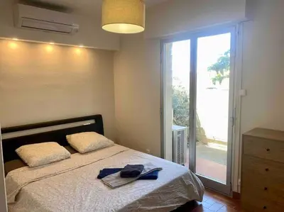 a bedroom with a bed and a large glass door at Beau T3 - plain pied - terrasses in Port-la-Nouvelle