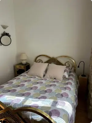 a bedroom with a bed with a colorful comforter at Chez Elise - Gîte de charme - Abbaye de Fontfroide in Bizanet