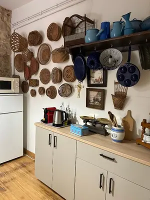 a kitchen with a counter with pots and pans on the wall at Chez Elise - Gîte de charme - Abbaye de Fontfroide in Bizanet