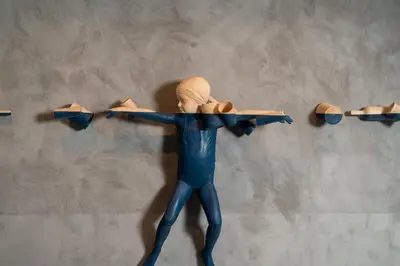 a statue of a man in a blue suit hanging on a wall at Bouquerie Lagrasse in Lagrasse