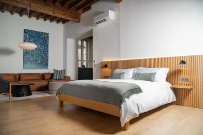 a bedroom with a large bed and a couch at Bouquerie Lagrasse in Lagrasse