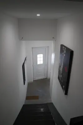 a hallway with a door and a picture on the wall at Loft Porte Sud 140 m2 in Salles-d'Aude