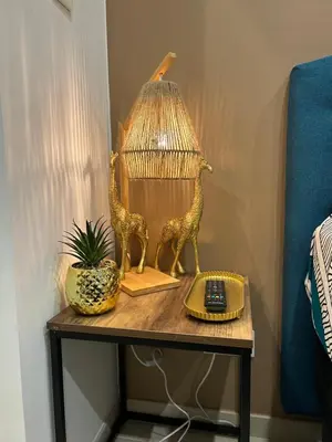 a table with a lamp and a phone and a pineapple at LA MADDYSON in Narbonne