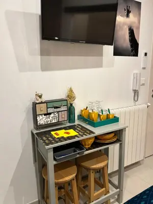 a table with two stools in a room at LA MADDYSON in Narbonne