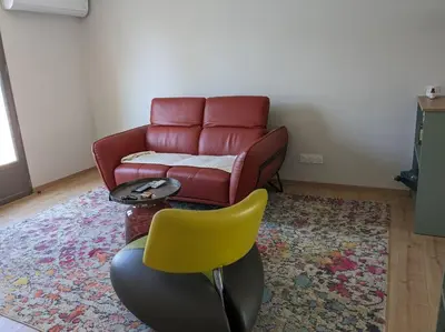 a living room with a couch and a chair at Petite Bulle in Narbonne