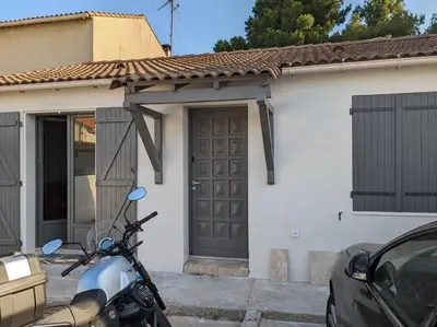 a motorcycle parked in front of a house at Petite Bulle in Narbonne
