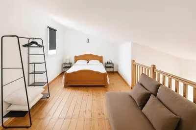 a living room with a bed and a couch at Appartement près du canal du midi in Mirepeisset