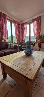 a living room with a wooden coffee table at Ferme-auberge le cochon du Madres in Escouloubre