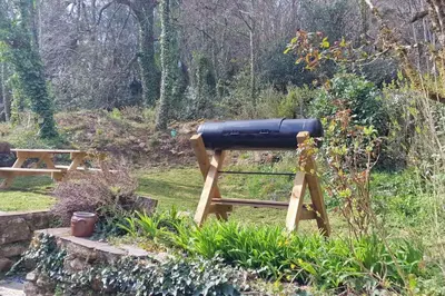 a cannon sitting on a stand in a garden at Maison au calme avec jardin et parking privé in Rouairoux