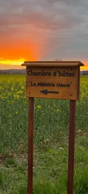 a wooden sign in the middle of a field at Chambre d'hôte in Revel